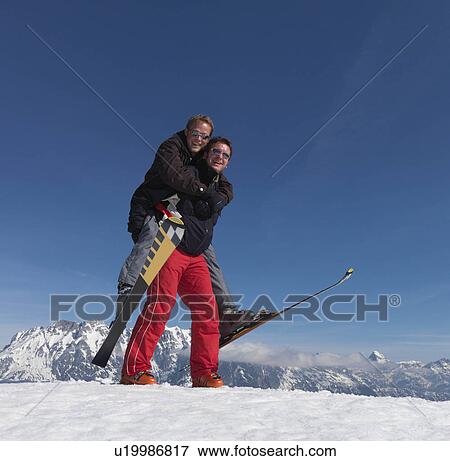 Skiers playing piggyback ride View Large Photo Image Stock Photo - Skiers playing piggyback ride. Fotosearch