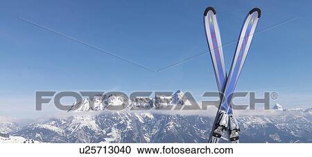 Stock Image - Skis in snow on top of mountain. Fotosearch