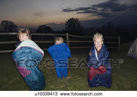 Stock Image - Sleeping bag races at dusk. Fotosearch