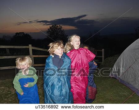 Stock Image - Sleeping bag races at dusk. Fotosearch
