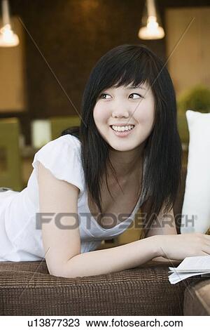 Stock Image - Smiling teen looking over shoulder. Fotosearch