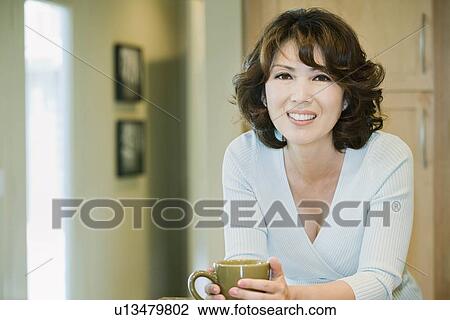 Smiling woman with coffee cup View Large Photo Image Stock Image - Smiling woman with coffee cup. Fotosearch