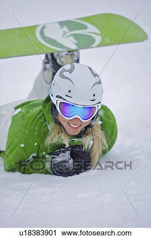 Stock Image - Snowboarder lying in the snow. Fotosearch