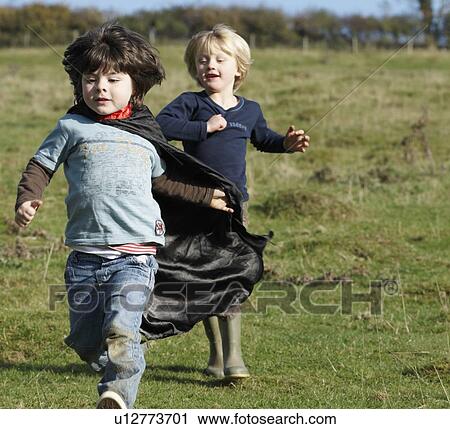 Super Hero boy and friend in field View Large Photo Image Stock Image - Super Hero boy and friend in field. Fotosearch