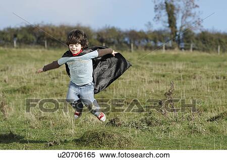 Stock Photography - Super Hero boy in field. Fotosearch