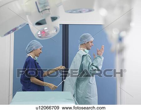 Surgeon and nurse preparing for surgery View Large Photo Image Stock Photo - Surgeon and nurse preparing for surgery. Fotosearch