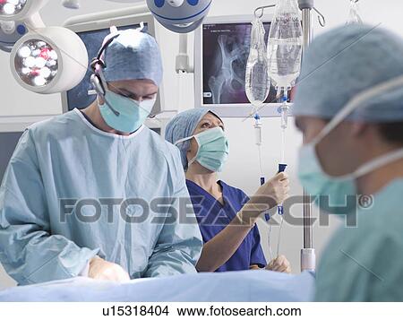 Picture - Surgeon and nurses during surgery. Fotosearch