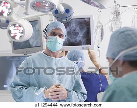 Picture - Surgeon and nurses in operating theatre. Fotosearch