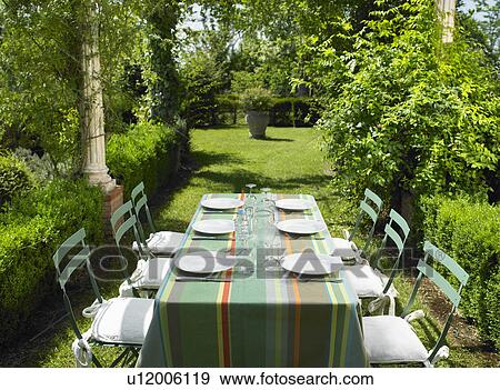 Table set in the garden View Large Photo Image Stock Photo - Table set in the garden. Fotosearch