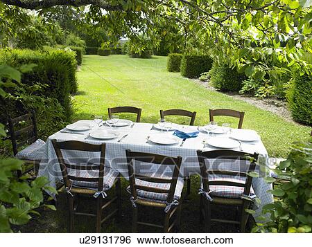 Stock Photograph - Table set in the garden. Fotosearch