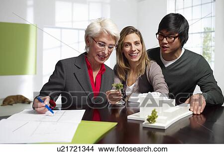 Team of international architects working View Large Photo Image Picture - Team of international architects working. Fotosearch