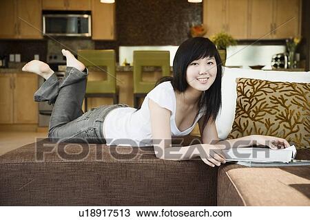 Teen girl relaxing with magazine View Large Photo Image Stock Image - Teen girl relaxing with magazine. Fotosearch