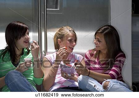 Teen girls laughing and eating View Large Photo Image Stock Photo - Teen girls laughing and eating. Fotosearch