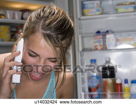 Picture - Teen laughing girl on telephone. Fotosearch
