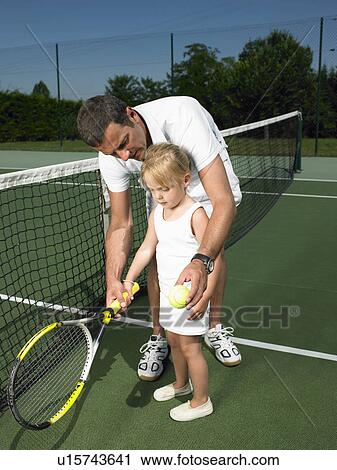 Stock Image - Tennis lesson for young child. Fotosearch