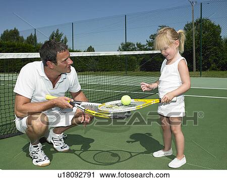Stock Image - Tennis lesson for young child. Fotosearch