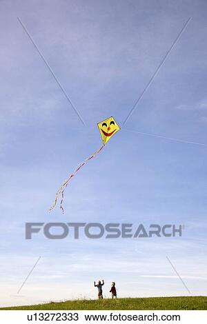 Two Boys fly a Kite View Large Photo Image Stock Image - Two Boys fly a Kite. Fotosearch