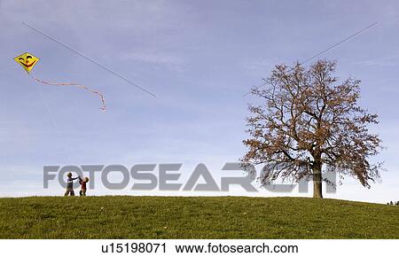 Stock Image - Two Boys fly a Kite. Fotosearch