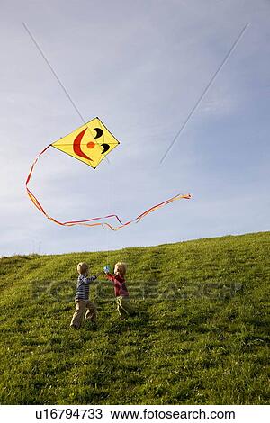 Two Boys fly a Kite View Large Photo Image Stock Image - Two Boys fly a Kite. Fotosearch