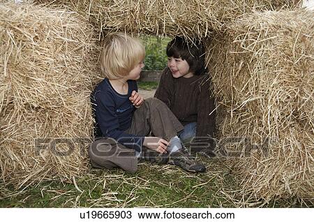 Two boys in hay bales View Large Photo Image Stock Image - Two boys in hay bales. Fotosearch