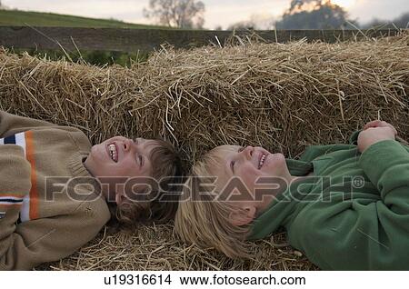Two boys on hay bales View Large Photo Image Picture - Two boys on hay bales. Fotosearch