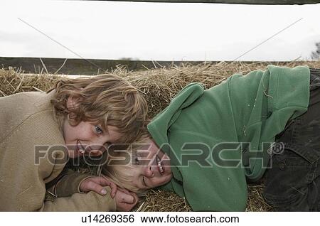 Two boys on hay bales View Large Photo Image Stock Photograph - Two boys on hay bales. Fotosearch