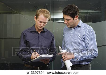 Picture - Two men discussing work. Fotosearch