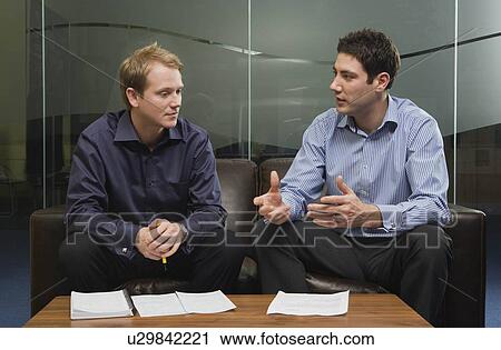 Stock Image - Two men having discussion. Fotosearch