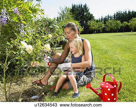 Woman and girl gardening View Large Photo Image Stock Image - Woman and girl gardening. Fotosearch