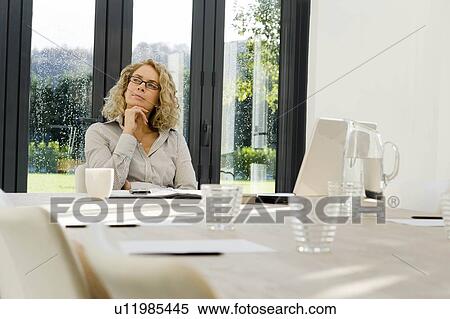 Stock Photography - Woman at work thinking. Fotosearch