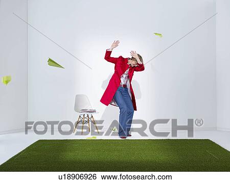 Stock Photograph - Woman being attacked by paper planes. Fotosearch