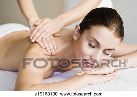 Stock Photo - Woman being massaged. Fotosearch