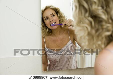 Woman brushing teeth View Large Photo Image Stock Photo - Woman brushing teeth. Fotosearch