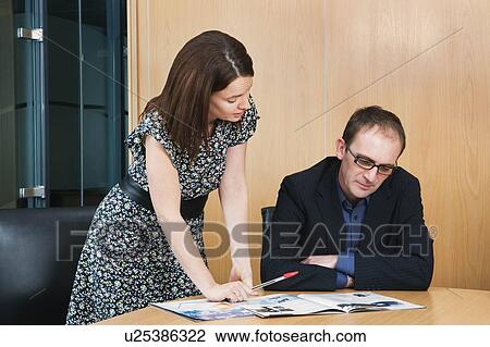 Woman discussing work with colleague View Large Photo Image Stock Image - Woman discussing work with colleague. Fotosearch