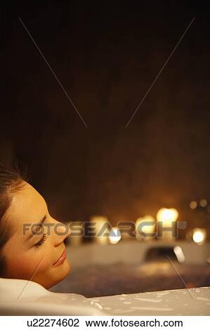 Stock Image - Woman in bubble bath. Fotosearch