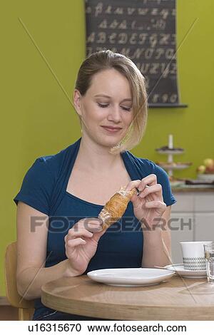 Woman in coffee shop with croissant View Large Photo Image Stock Image - Woman in coffee shop with croissant. Fotosearch