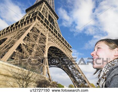 Stock Image - Woman in front of Eiffel tower. Fotosearch