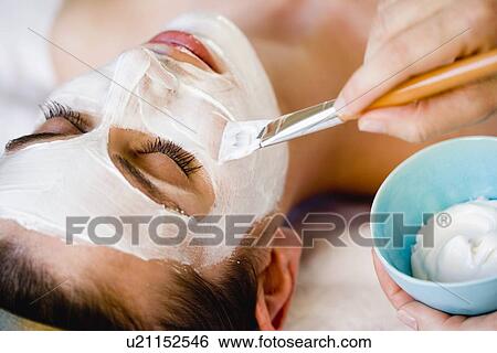 Woman is getting a face mask View Large Photo Image Stock Photograph - Woman is getting a face mask. Fotosearch