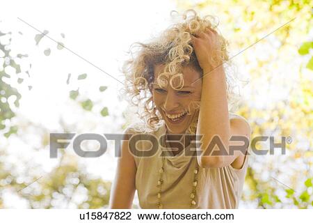 Stock Image - Woman laughing enjoying leisure time. Fotosearch