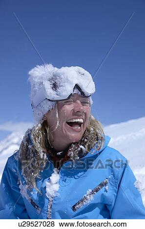 Stock Photo - "Woman laughing, face covered with snow". Fotosearch
