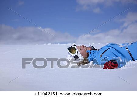 "Woman laughing, lying in snow" View Large Photo Image Stock Image - "Woman laughing, lying in snow". Fotosearch