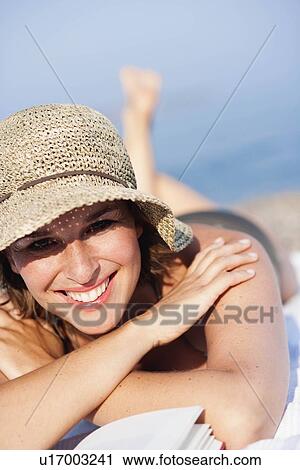 Woman laying on the beach View Large Photo Image Stock Image - Woman laying on the beach. Fotosearch
