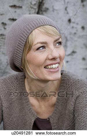Woman leaning at tree laughing View Large Photo Image Stock Image - Woman leaning at tree laughing. Fotosearch