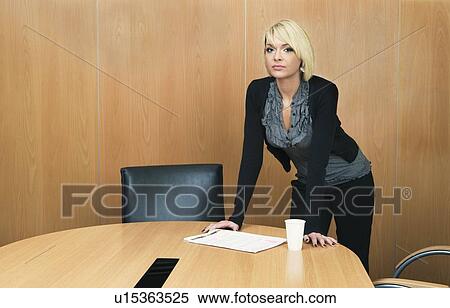 Woman leaning on boardroom table View Large Photo Image Stock Photography - Woman leaning on boardroom table. Fotosearch