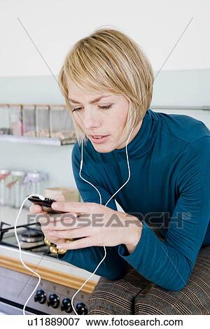 Stock Photo - Woman listening to music with headphones. Fotosearch