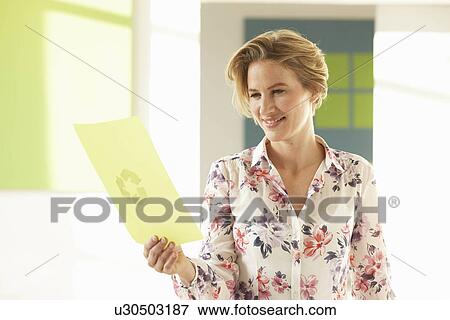 Woman looking at green print View Large Photo Image Stock Photo - Woman looking at green print. Fotosearch