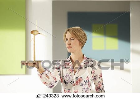 Woman looking at wooden wind wheel View Large Photo Image Stock Image - Woman looking at wooden wind wheel. Fotosearch
