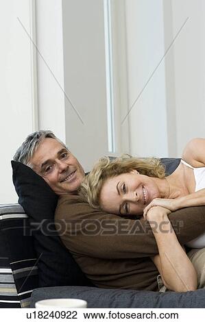 Stock Image - Woman on sofa. Fotosearch
