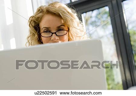 Stock Image - Woman on the computer. Fotosearch