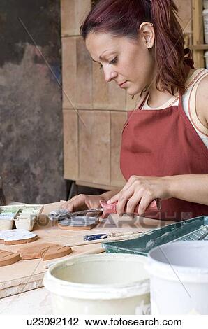 Woman painting clay flowers View Large Photo Image Stock Image - Woman painting clay flowers. Fotosearch